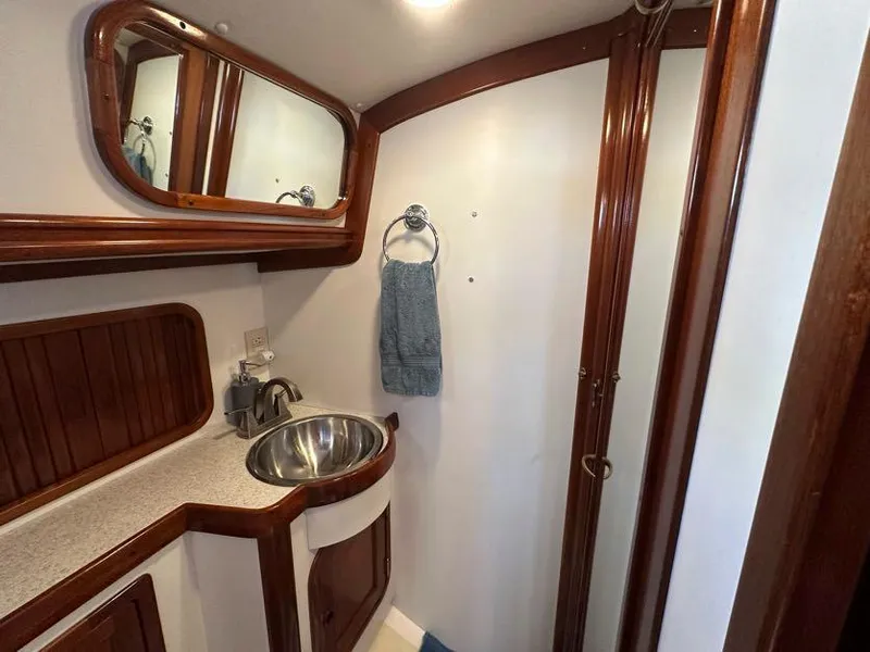 Slide: The Image of Interior of 2000 Legacy 40 Sedan with wooden cabinetry and snack storage. - 39