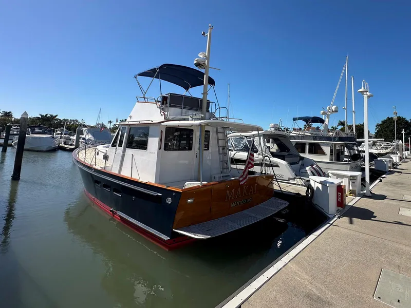 Slide: The Image of Legacy Yachts 40 Sedan 2000 docked at marina under clear blue sky. - 4