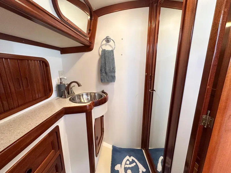 Slide: The Image of Interior of 2000 Legacy 40 Sedan with wooden stairs and compact kitchen area. - 40