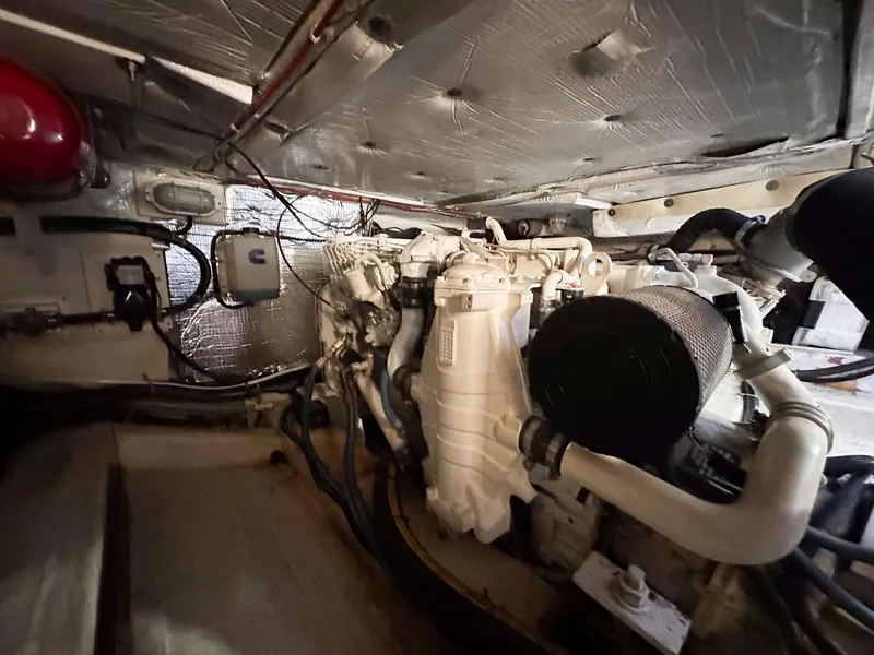 Slide: The Image of Engine room of 2000 Legacy Yachts 40 Sedan, showcasing mechanical components and wiring. - 49