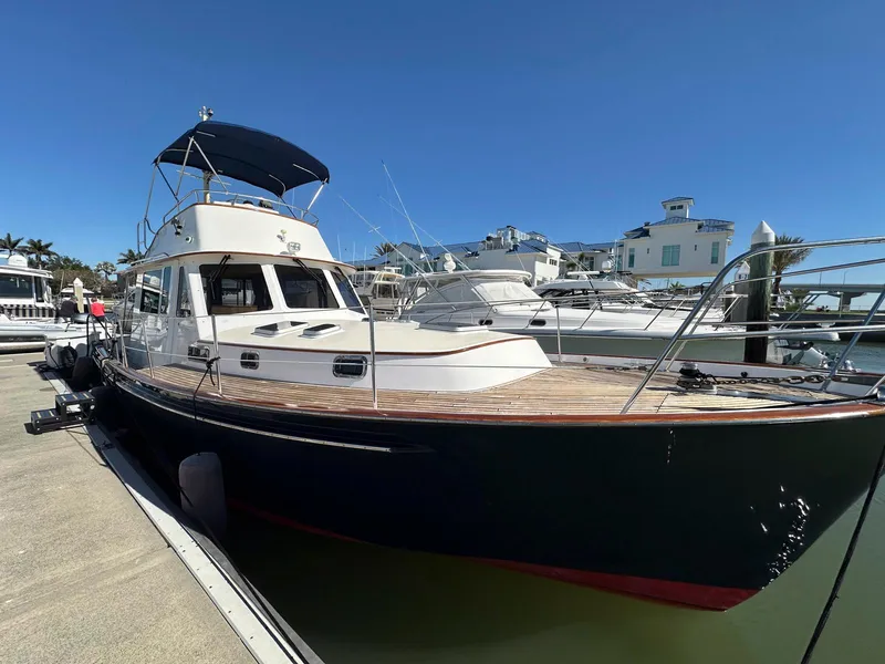 Slide: The Image of 2000 Legacy Yachts 40 Sedan docked, featuring sleek design and spacious deck. - 5