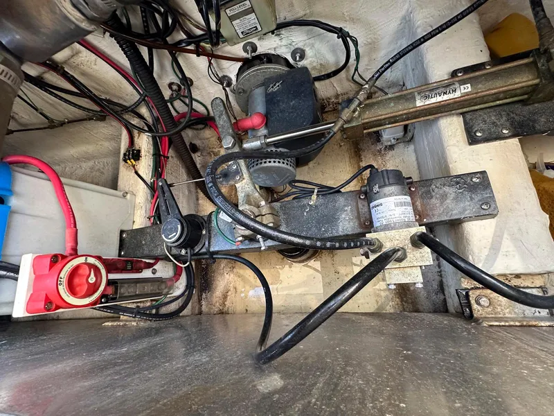 Slide: The Image of Engine compartment of a 2000 Legacy Yachts 40 Sedan, showing wiring and mechanical components. - 52