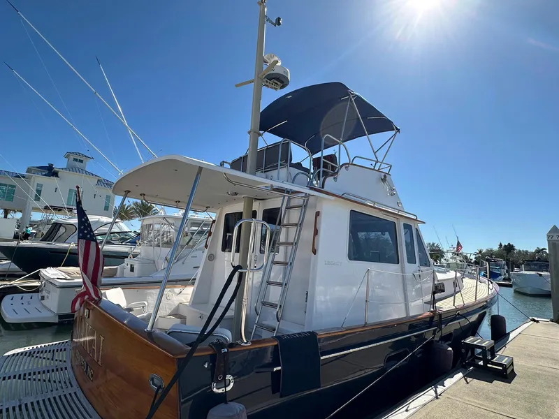 Slide: The Image of 2000 Legacy Yachts 40 Sedan docked under clear blue sky. - 6