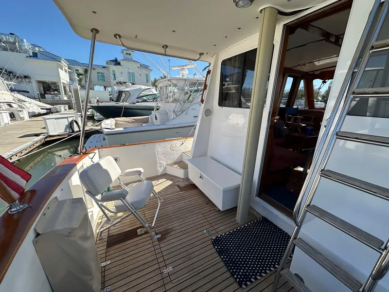 Slide: The Image of 2000 Legacy Yachts 40 Sedan, spacious deck with seating, docked at marina. - 8