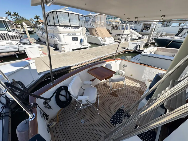 Slide: The Image of Legacy Yachts 40 Sedan 2000 model, docked with outdoor seating area, marina view. - 9