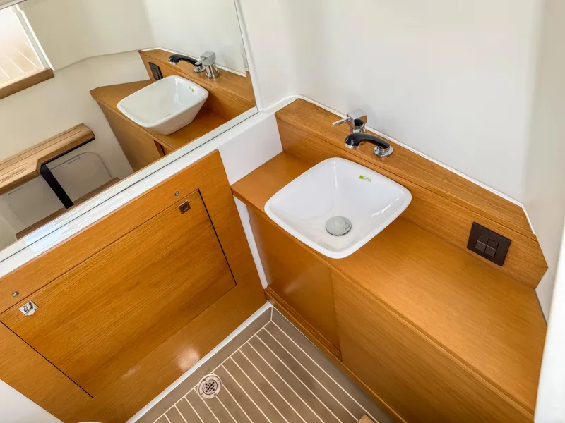 Slide: The Image of 2024 De Antonio Yachts D28 Open bathroom with wooden cabinetry and modern sink design. - 12