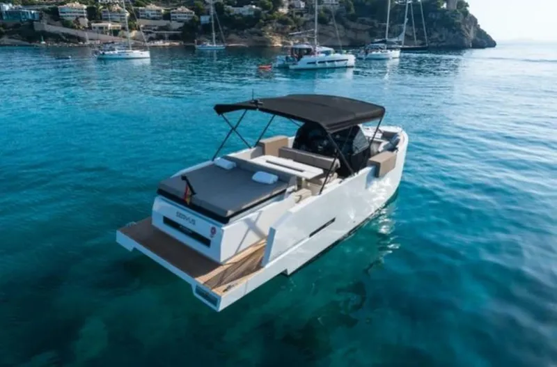 Slide: The Image of 2024 De Antonio Yachts D28 Open on clear blue water, featuring sleek design and spacious deck. - 0