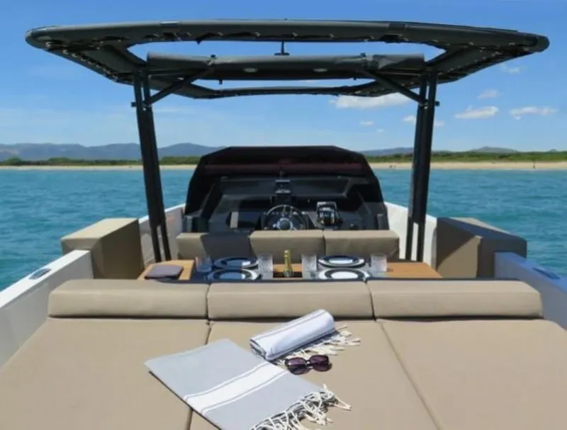 Slide: The Image of 2024 De Antonio Yachts D28 Open on water, featuring spacious deck and modern design. - 4