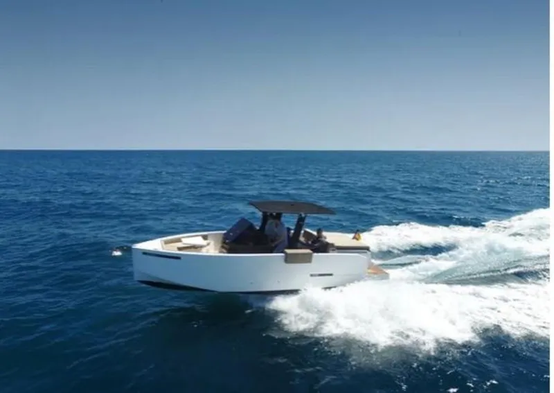 Slide: The Image of 2024 De Antonio Yachts D28 Open cruising on open sea under clear blue sky. - 6