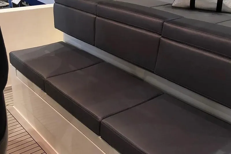 Slide: The Image of 2024 De Antonio Yachts D28 Xplorer seating area with sleek, dark cushions. - 15