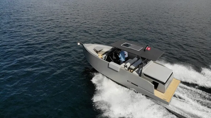 Slide: The Image of 2024 De Antonio Yachts D28 Xplorer cruising on open water, aerial view. - 2