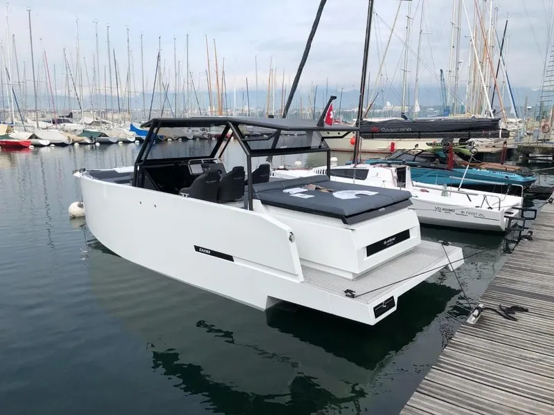 Slide: The Image of 2024 De Antonio Yachts D28 Xplorer docked in a marina, showcasing sleek design and modern features. - 3
