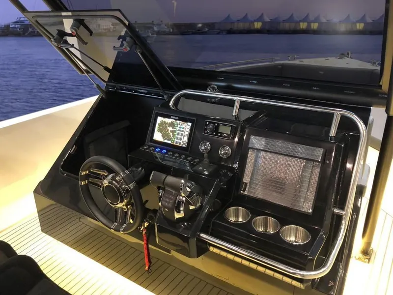 Slide: The Image of 2024 De Antonio Yachts D28 Xplorer cockpit with navigation system and controls at sunset. - 9