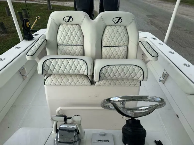 Slide: The Image of 2008 Jupiter 31 FS Center Console boat with dual cushioned seats and steering wheel. - 12