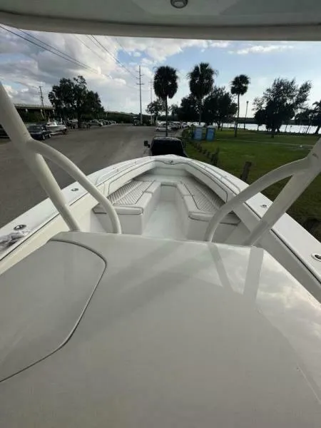 Slide: The Image of 2008 Jupiter 31 FS Center Console boat on a road near palm trees and water. - 13