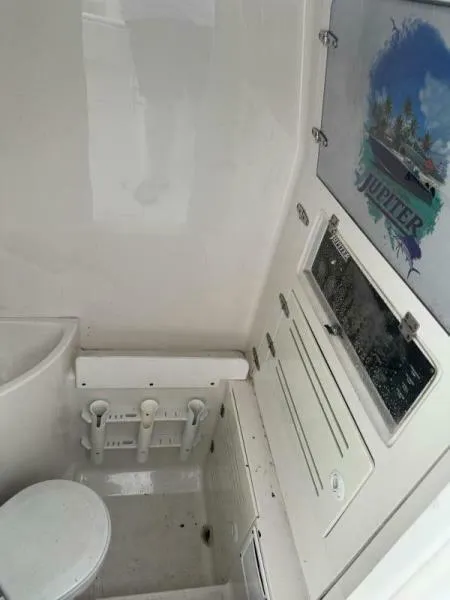 Slide: The Image of Interior of 2008 Jupiter 31 FS Center Console boat with storage and seating. - 15