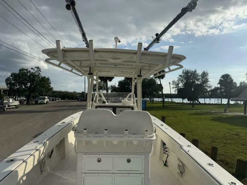 Slide: The Image of 2008 Jupiter 31 FS Center Console boat docked, featuring spacious deck and fishing rod holders. - 8