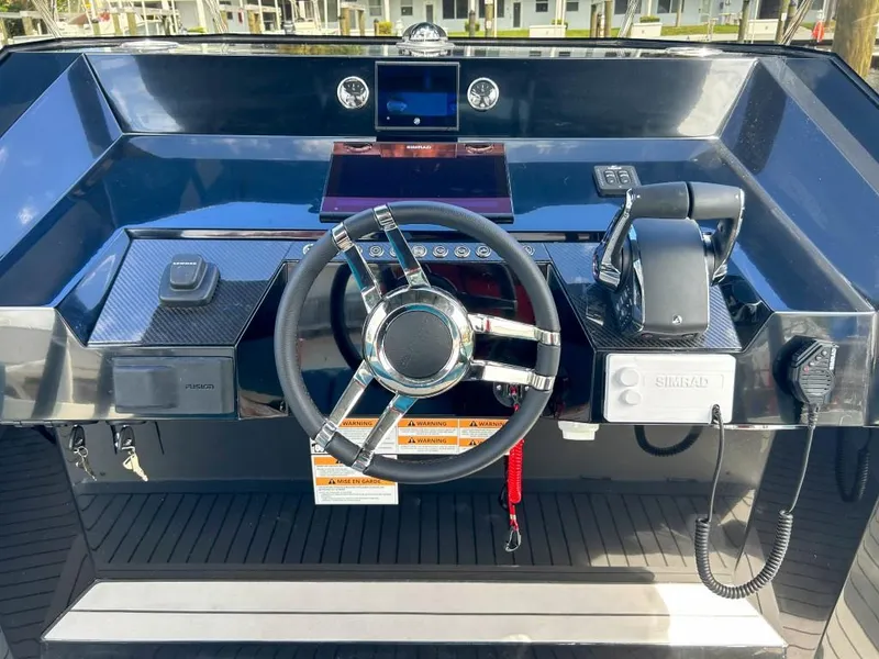 Slide: The Image of Helm of 2023 De Antonio Yachts D28 Open, featuring modern controls and steering wheel. - 11