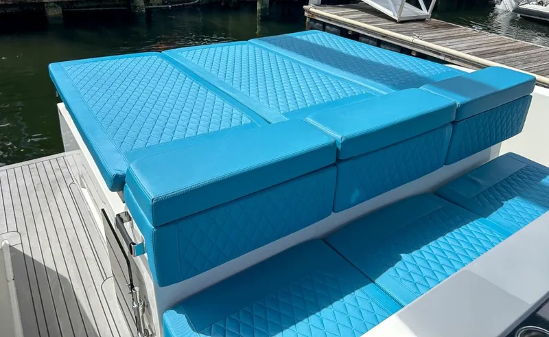 Slide: The Image of 2023 De Antonio Yachts D28 Open with blue quilted seating, docked by the water. - 17