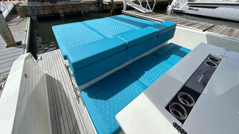 Slide: The Image of 2023 De Antonio Yachts D28 Open with turquoise seating, docked at a marina. - 18