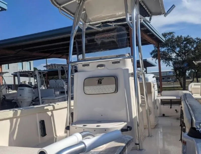 Slide: The Image of 2022 Carolina Skiff 23 LS boat, center console, docked under a canopy. - 4