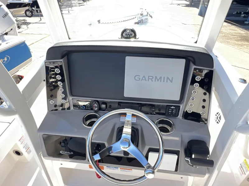 Slide: The Image of 2024 Robalo 246 Cayman boat dashboard with Garmin display and steering wheel. - 10