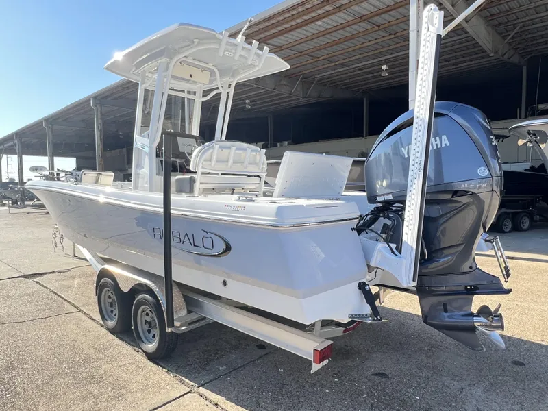 Slide: The Image of 2024 Robalo 246 Cayman boat with Yamaha engine on trailer in marina. - 14