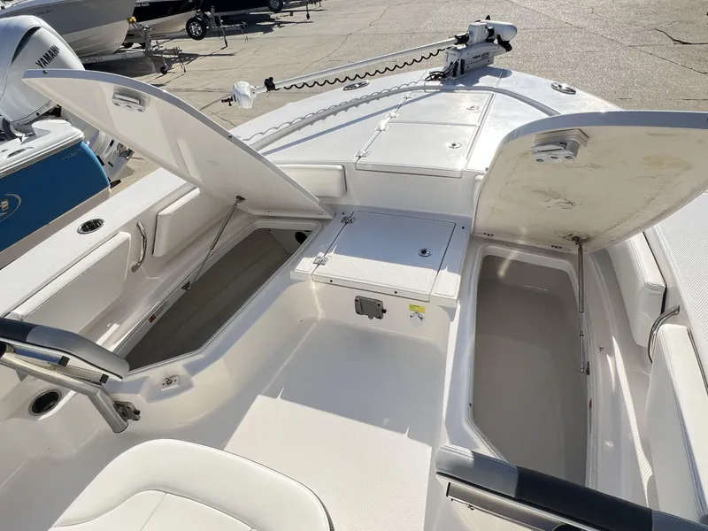 Slide: The Image of 2024 Robalo 246 Cayman boat interior with open storage compartments and seating. - 5