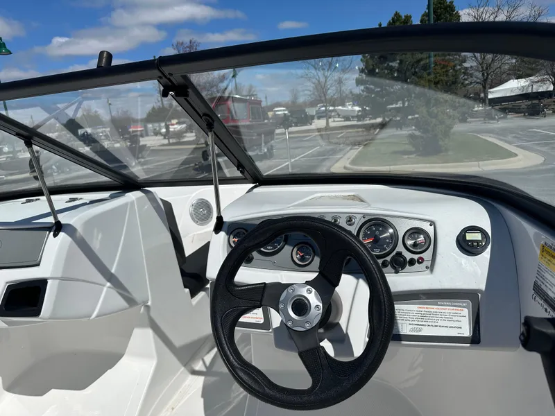 Slide: The Image of 2024 Tahoe 185 S boat dashboard with steering wheel and gauges. - 4