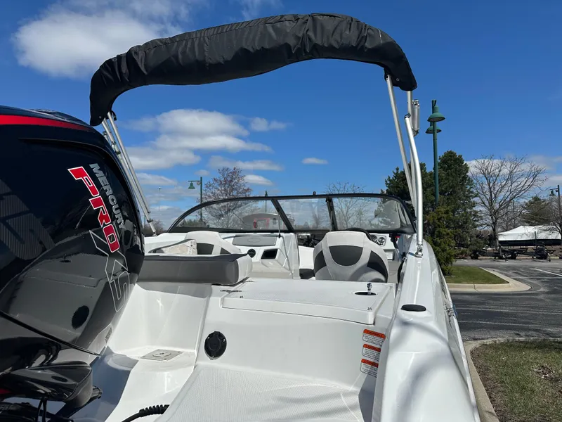 Slide: The Image of 2024 Tahoe 185 S boat with F PRO engine, parked outdoors under a clear blue sky. - 6