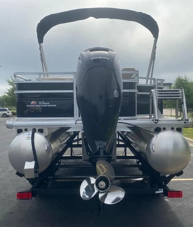 Slide: The Image of 2024 Sun Tracker SportFish 20 DLX pontoon boat, rear view with motor and canopy. - 7