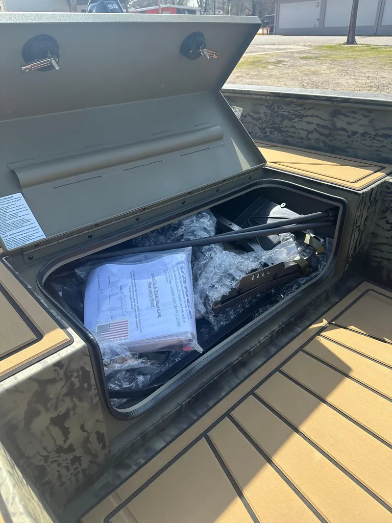 Slide: The Image of Open storage compartment in 2025 Tracker Grizzly 1650 T Prairie Wings Edition boat. - 11