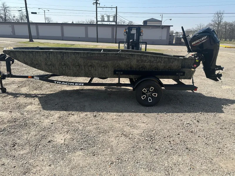 Slide: The Image of 2025 Tracker Grizzly 1650 T Prairie Wings Edition boat on trailer, side view. - 2