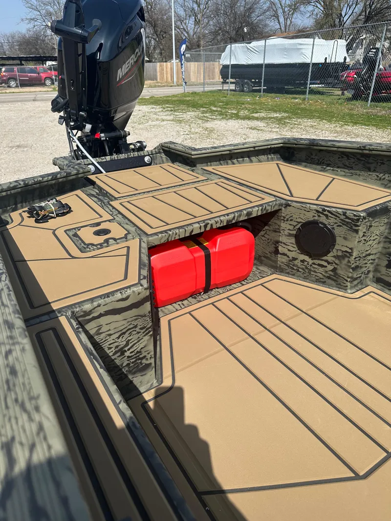 Slide: The Image of 2025 Tracker Grizzly 1650 T Prairie Wings Edition boat interior with red fuel tank. - 6