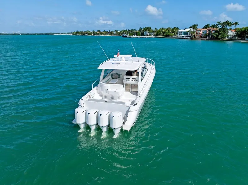 Slide: The Image of 2018 Intrepid 475 Sport Yacht cruising on turquoise waters under a clear sky. - 11