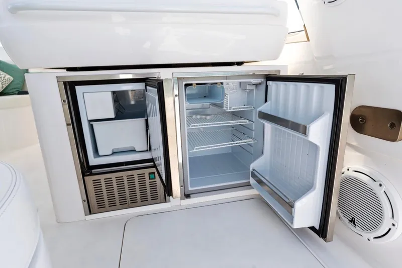 Slide: The Image of 2018 Intrepid 475 Sport Yacht open mini fridge and freezer on deck. - 19