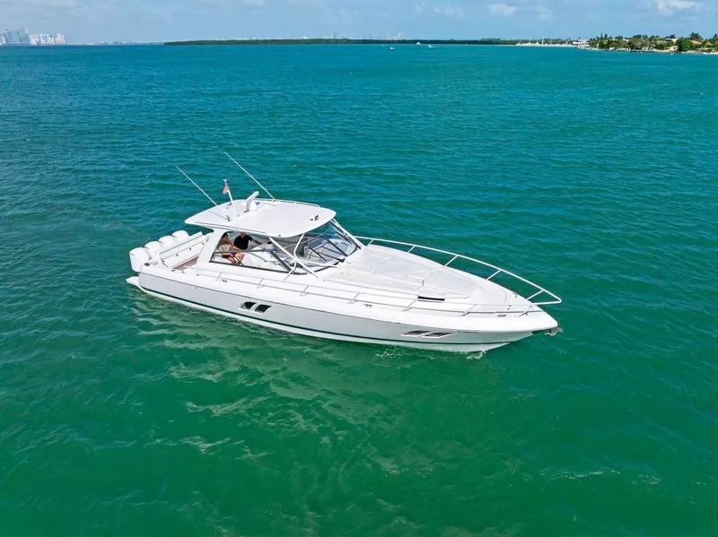 Slide: The Image of 2018 Intrepid 475 Sport Yacht cruising on clear blue waters. - 2