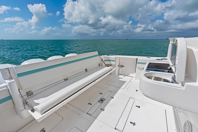 Slide: The Image of 2018 Intrepid 475 Sport Yacht deck with seating and ocean view. - 26