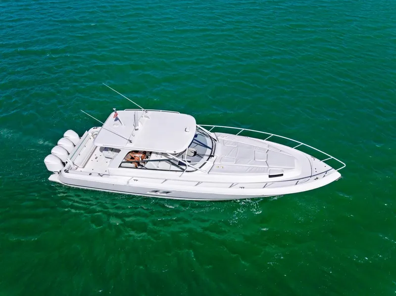 Slide: The Image of 2018 Intrepid 475 Sport Yacht cruising on clear turquoise water. - 3