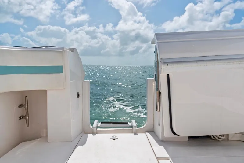 Slide: The Image of 2018 Intrepid 475 Sport Yacht, rear view, overlooking ocean under cloudy sky. - 30