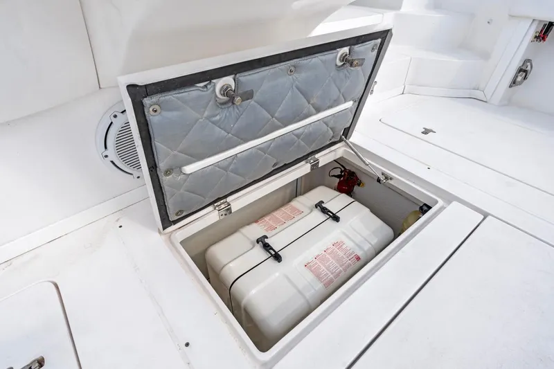Slide: The Image of Open storage compartment on 2018 Intrepid 475 Sport Yacht deck, revealing equipment inside. - 33