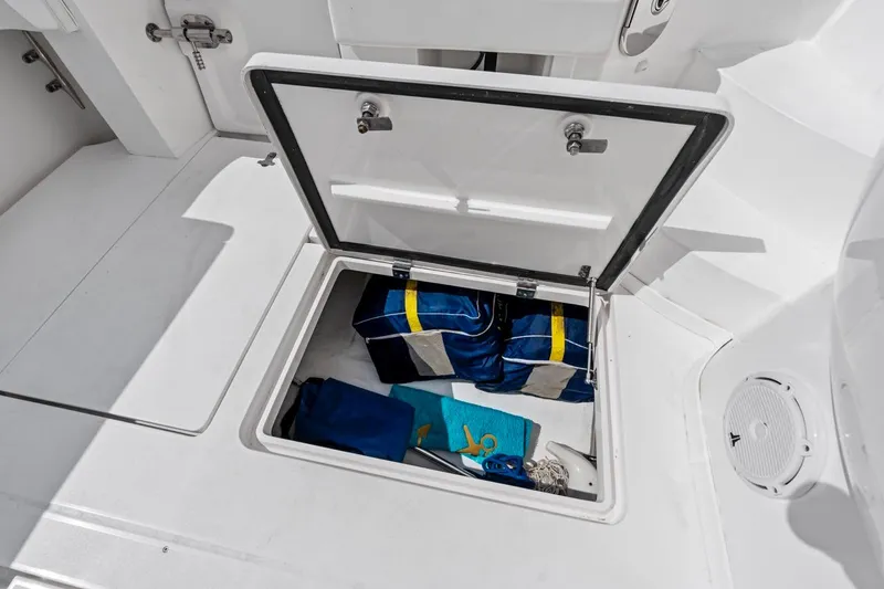 Slide: The Image of Storage compartment on 2018 Intrepid 475 Sport Yacht with life jackets and gear. - 34