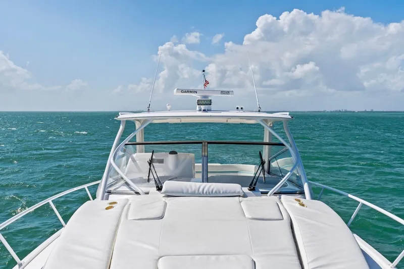 Slide: The Image of 2018 Intrepid 475 Sport Yacht cruising on open sea under clear skies. - 38