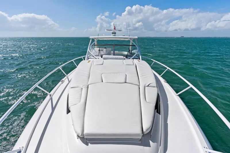 Slide: The Image of 2018 Intrepid 475 Sport Yacht cruising on open sea under clear skies. - 40