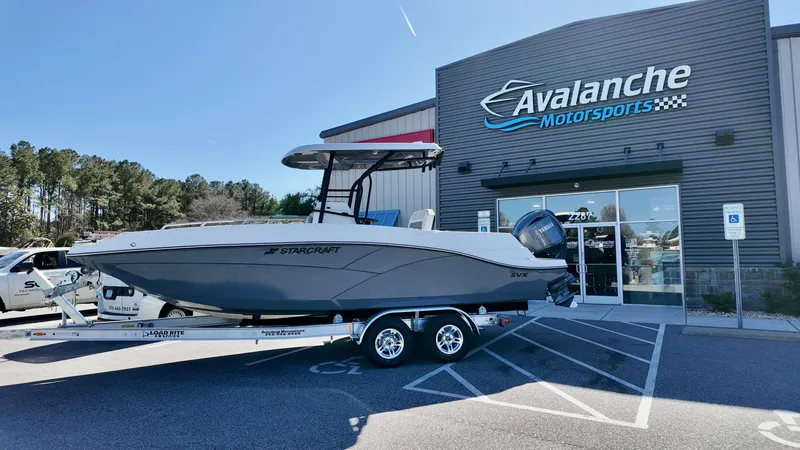 The Image of 2025 Starcraft SVX 231 OB CC boat on trailer at Avalanche Motorsports dealership. - 1
