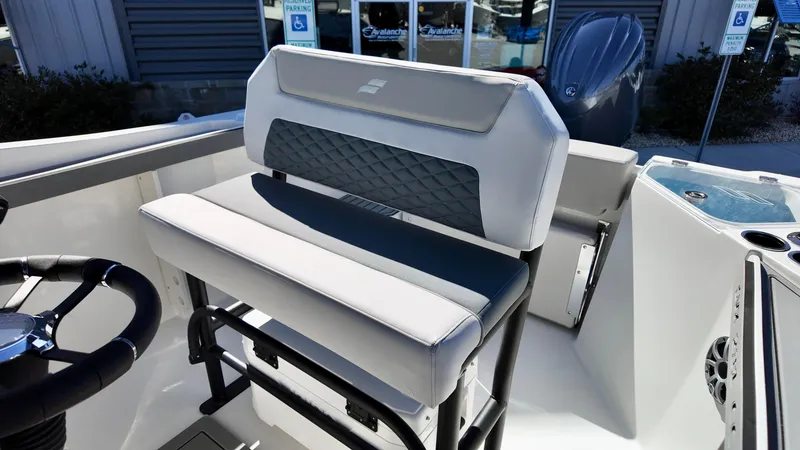 Slide: The Image of 2025 Starcraft SVX 231 OB CC boat interior with cushioned seating and steering wheel. - 11
