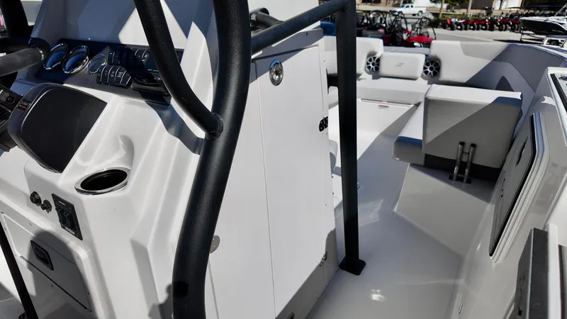 Slide: The Image of 2025 Starcraft SVX 231 OB CC boat interior with modern console and seating. - 8