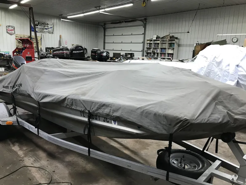 Slide: The Image of 1997 Bass Tracker Pro Team 175 boat covered in a garage. - 13