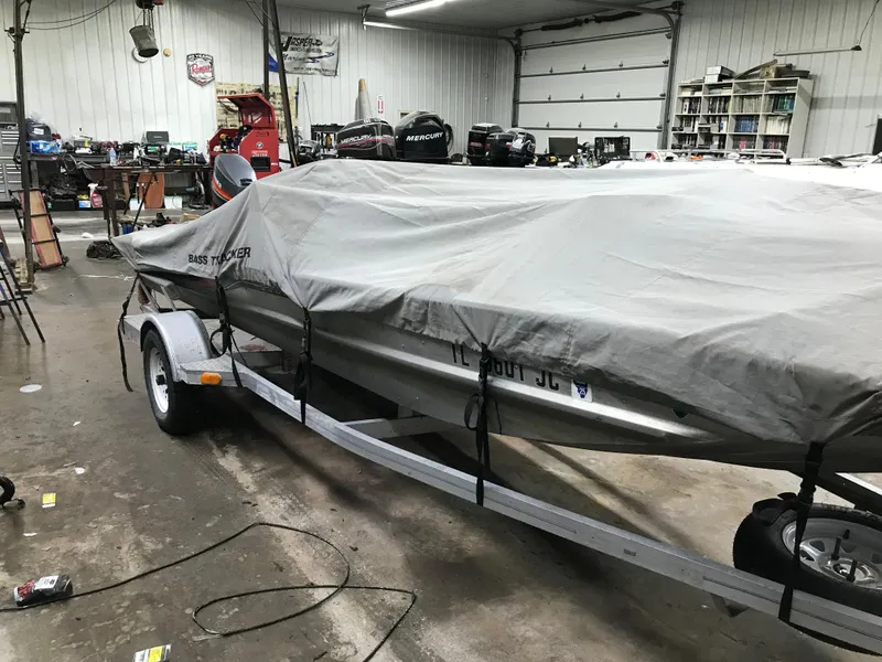 Slide: The Image of 1997 Bass Tracker Pro Team 175 boat covered in a garage setting. - 14