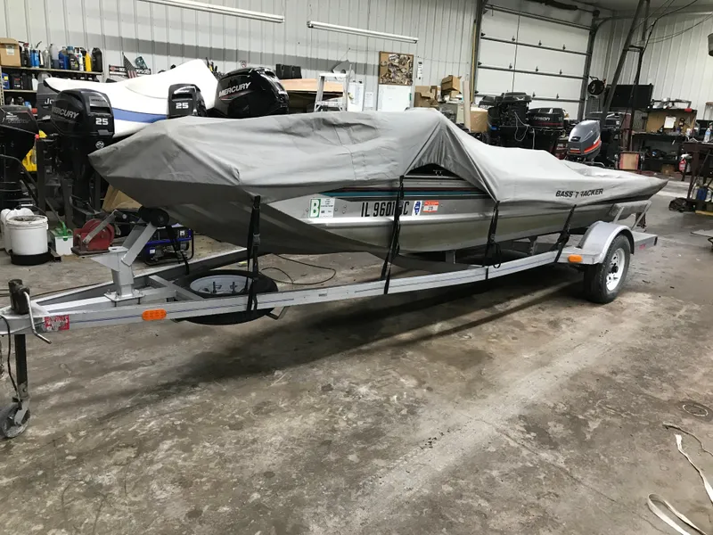 Slide: The Image of 1997 Bass Tracker Pro Team 175 boat covered on trailer in garage. - 17